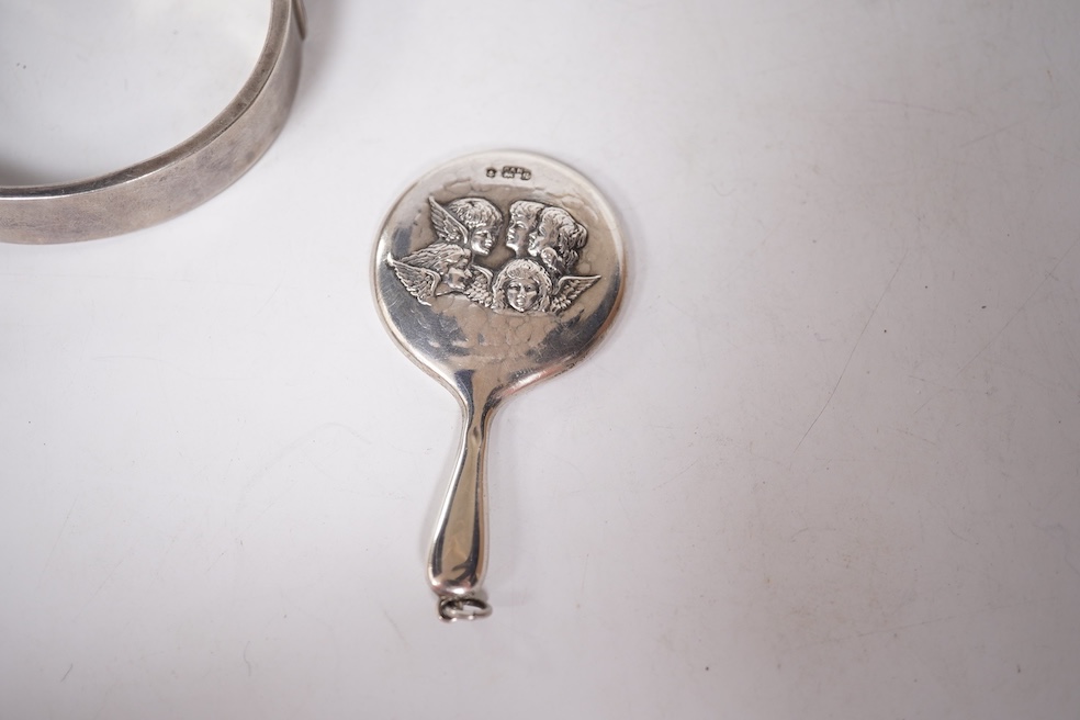A late Victorian white metal and Scottish hardstone set 'X' brooch with coronet, 34mm, together with a silver hinged bangle and a George V silver mounted handbag mirror, with Reynold's Angels decoration. Condition - poor